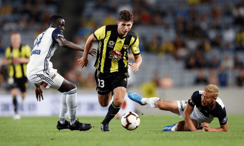 Liberato Cacace of the Wellington Phoenix charging through Melbourne Victory players at Eden Park (Getty Images)  
