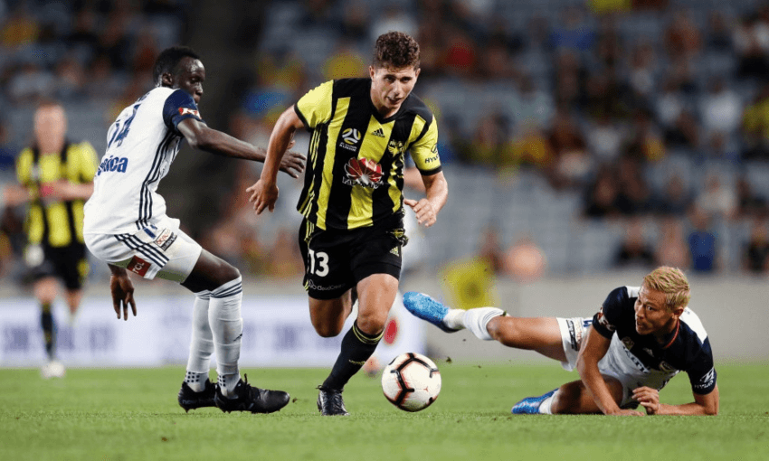 Liberato Cacace of the Wellington Phoenix charging through Melbourne Victory players at Eden Park (Getty Images)