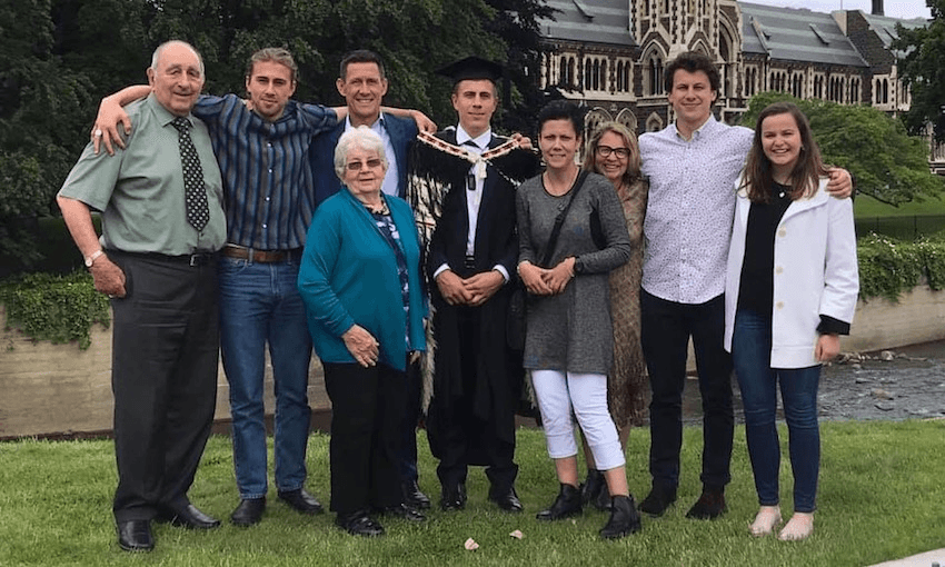 Recent Otago graduate Jack Tapsell (in gown) with his parents, siblings and extended whānau. Image: supplied 
