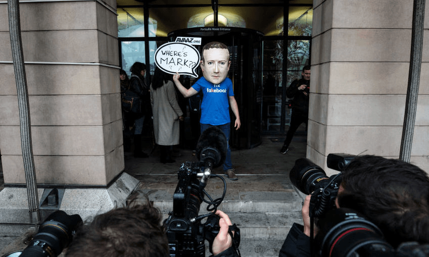 A protester wearing a model head of Facebook CEO Mark Zuckerberg outside the UK inquiry in November 2018. (Photo by Jack Taylor/Getty Images) 

