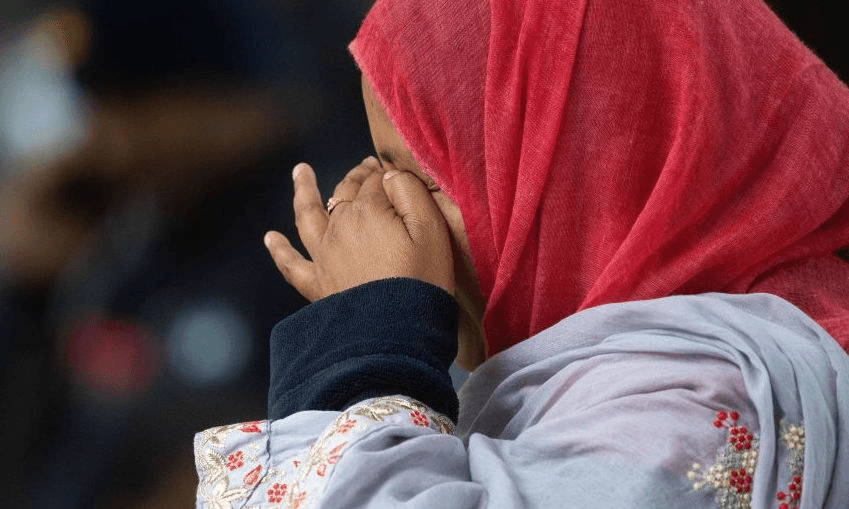 A member of Christchurch’s Muslim community stands across the road from the Dean Street mosque. (Photo: MARTY MELVILLE/AFP/Getty Images)