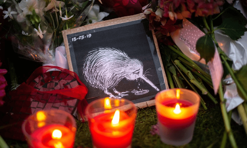 Candles burn next to a picture of a weeping Kiwi among other tributes by the wall of the Botanic Garden (Photo by Carl Court/Getty Images) 
