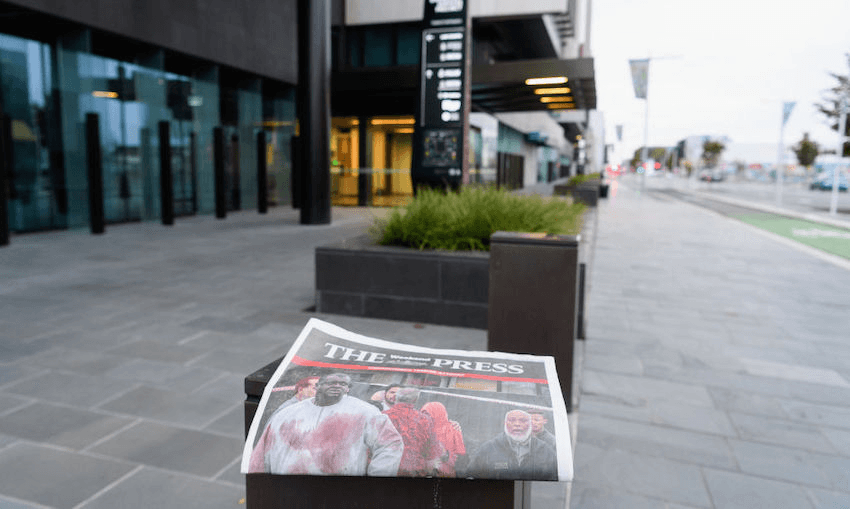 The cover of the March 16 2019 edition of The Press is seen in front of Christchurch District Court where the suspected shooter was due to appear in court. (Photo by Kai Schwoerer/Getty Images) 
