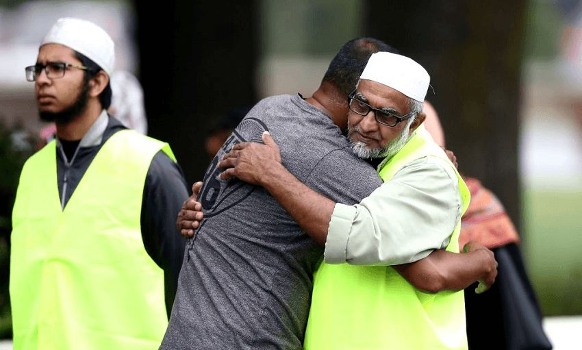 Members of the Muslim community embrace outside the community centre in Christchurch following the March 15 terror attacks (Photo: Hannah Peters/Getty Images) 
