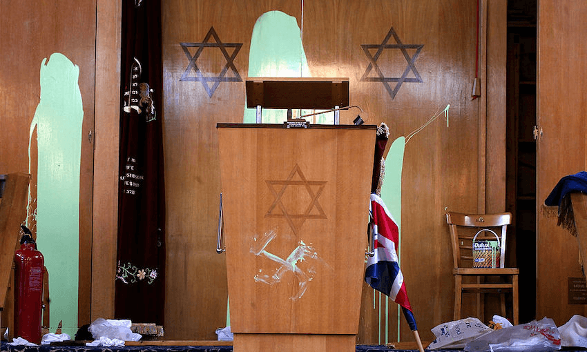 A swastika is daubed beneath the Star of David on a preaching lectern April 30, 2002 at Finsbury Park Synagogue in London. (Photo by Sion Touhig/Getty Images) 
