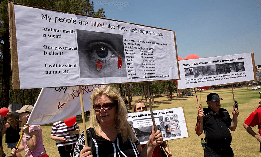 White South Africans hold placards during a protest against the violent murder of farmers which they term “genocide and oppressive state policies in favour of blacks” in Pretoria in 2013 (Photo: ALEXANDER JOE/AFP/Getty Images) 
