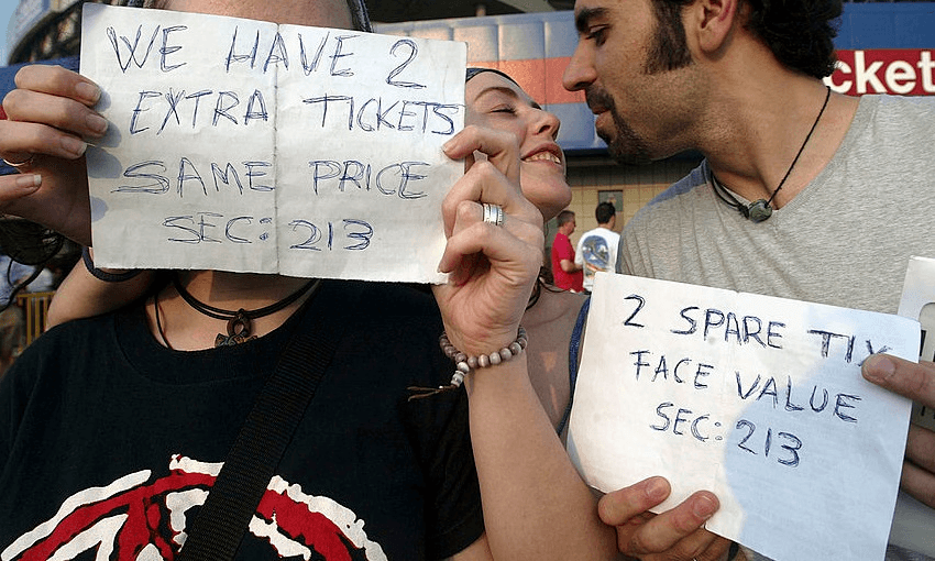 Fans hold signs while attempting to sell extra tickets for a Bruce Springsteen concert in New Jersey in 2003 (Photo: Mario Tama/Getty Images) 
