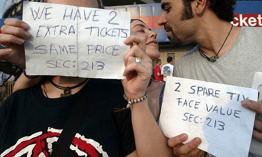 Fans hold signs while attempting to sell extra tickets for a Bruce Springsteen concert in New Jersey in 2003 (Photo: Mario Tama/Getty Images)