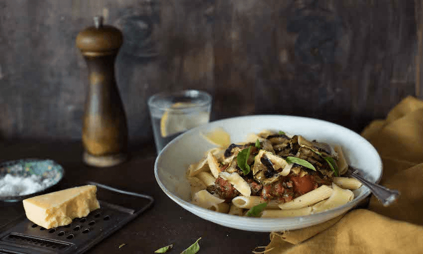 Long, slow cooking develops the sweetness and depth of the tomatoes, and baked zucchini, basil and parmesan rounds out a damn good dinner (Photo: Emma Boyd) 
