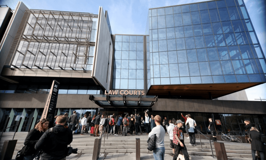 Journalists wait outside the Christchurch District Court following the March 15 terror attacks in 2019 (Photo by Sanka Vidanagama/NurPhoto)