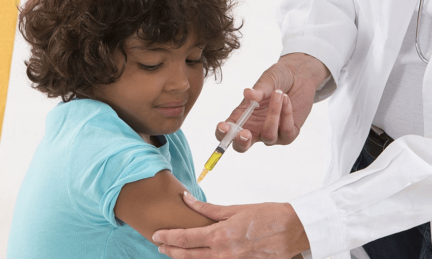 A child being very brave about getting a vaccination (Getty Images)  
