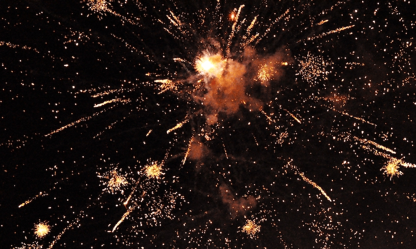 a black sky with fireworks exploding in the background