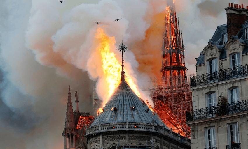 Smoke and flames rise during a fire at the landmark Notre-Dame Cathedral in central Paris on April 15, 2019. (Photo: FRANCOIS GUILLOT/AFP/Getty Images) 
