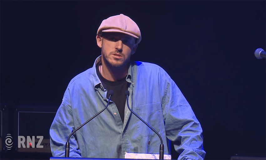 Tom Scott accepts the 2019 Tait. Image: YouTube/RNZ. 
