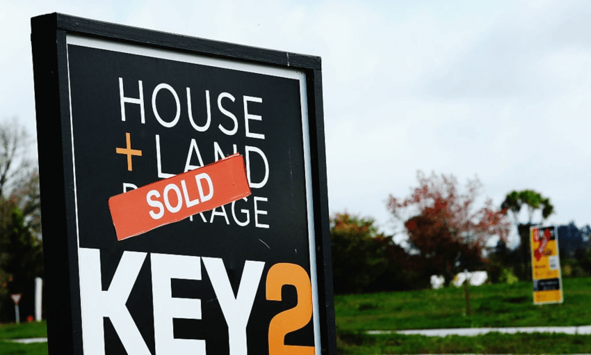 Sale signs on houses in the Riverhead development in Auckland’s northwest. (Photo: Getty Images) 
