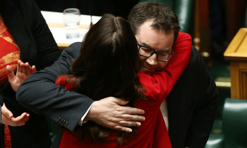 Grant Robertson embraces Prime Minister Jacinda Ardern after delivering the 2019 budget presentation at Parliament (Photo by Hagen Hopkins/Getty Images)