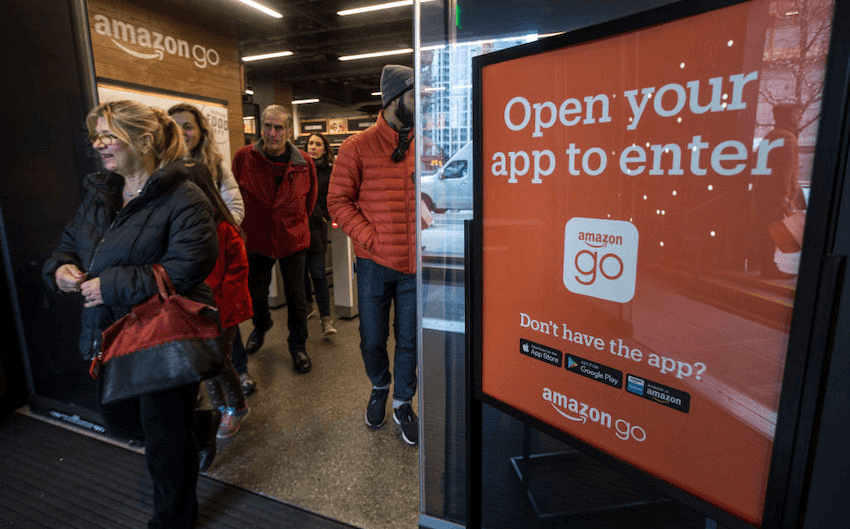 Shoppers leave the Amazon Go store after checking out on January, 22 2018 in Seattle, Washington. (Photo by Stephen Brashear/Getty Images) 
