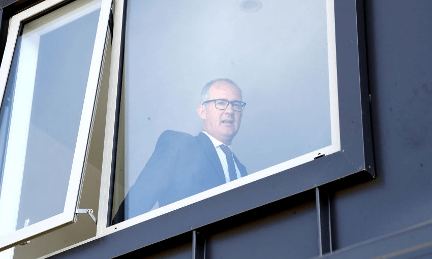 Phil Twyford looking out the window of a new Kiwibuild house (Getty Images) 
