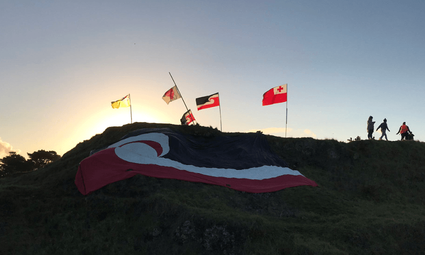 Flags fly on the maunga at Ihumātao. Photo: Don Rowe. 
