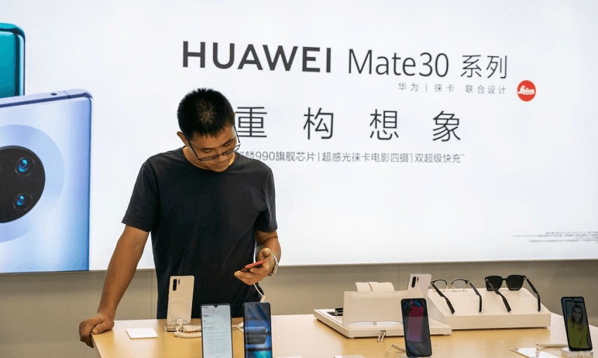 A customer browsing Huawei’s flagship Mate 30 Series in Shanghai (Photo by Alex Tai/SOPA Images/LightRocket via Getty Images) 
