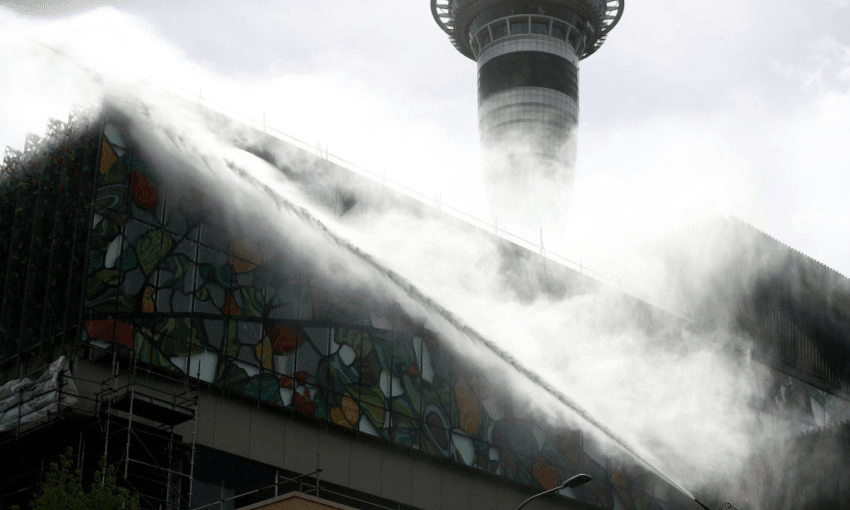 Firefghters continue to douse the roof of the SkyCity Convention Centre. Photo by Phil Walter/ Getty Images