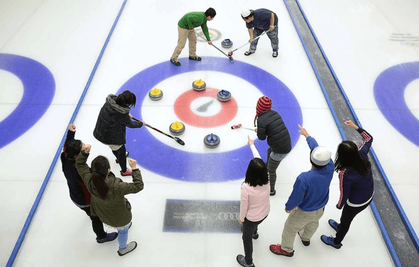 A close curling match between a group of friends at the indoor ice rink in Naseby, Central Otago. 