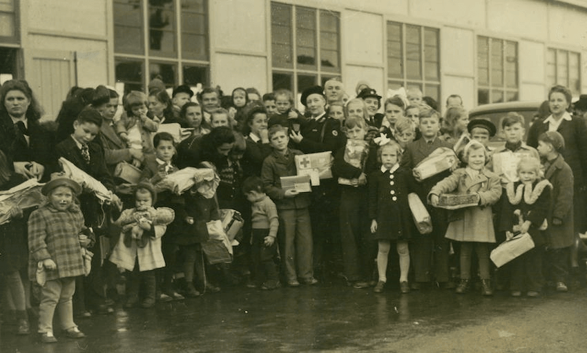 Safe at last in New Zealand, the newly-arrived Polish children face the camera with their parcels, 1944 (Alexander Turnbull Library) 
