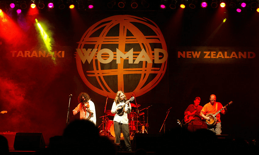 A shot of a three-piece band playing at WOMAD in New Plymouth