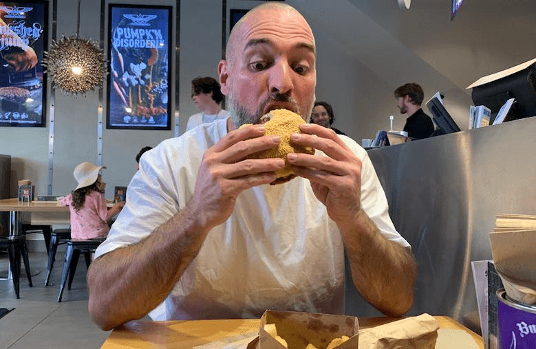 The Spinoff's Simon Day, wide-mouthed and preparing to absolutely go to town on BurgerFuel's Alternative Muscle burger.