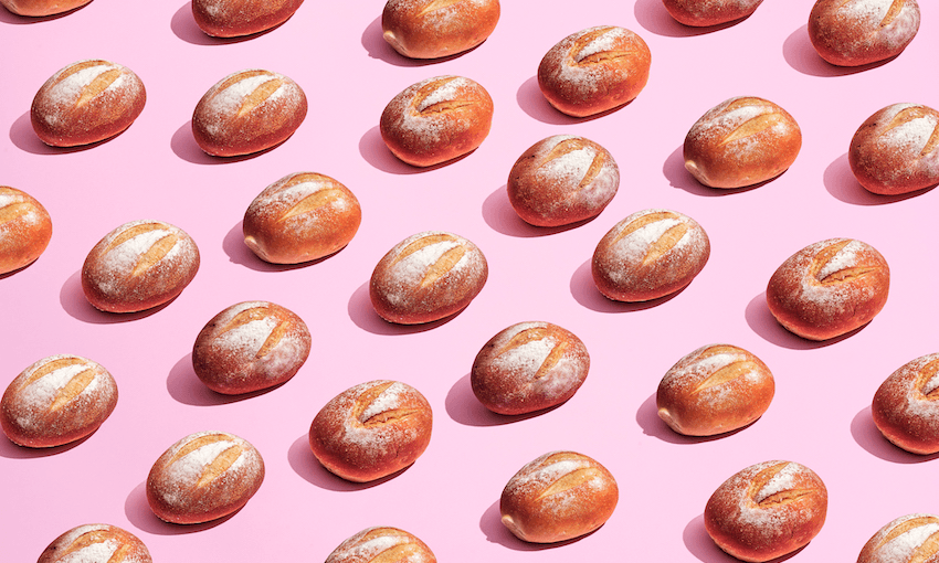 multiple loaves of bread against a pink background