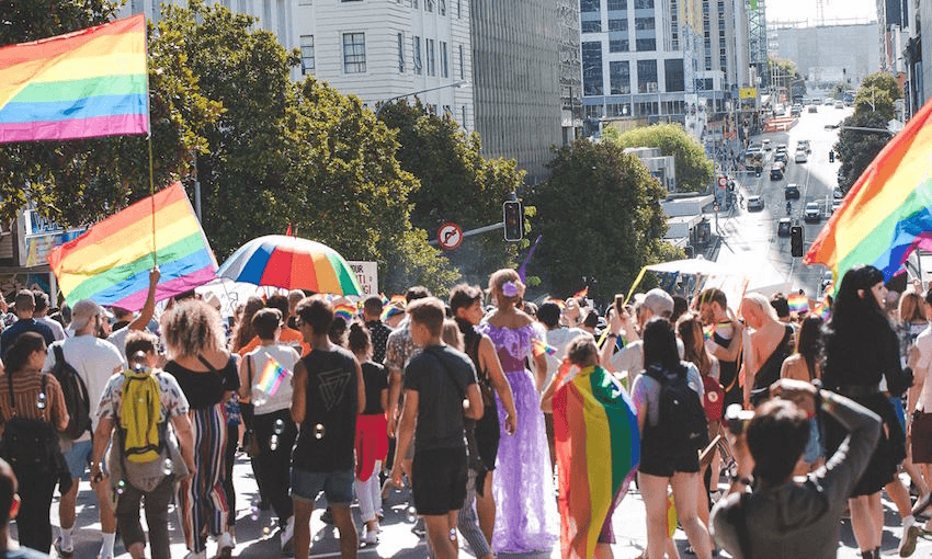 Three thousand marchers block Auckland central roads waving pride flags. Photo: JJ Allen. 
