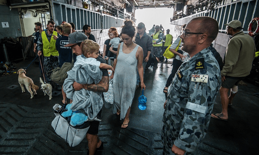 The Australian Navy evacuates residents and tourists stranded by bushfires in Mallacoota, NSW (Photo: Justin McManus/SMH via Getty.) 
