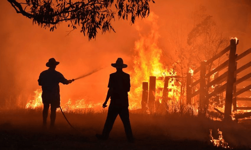 Residents defend a property from a bushfire at Hillsville near Taree, 350km north of Sydney on November 12, 2019. (Photo by PETER PARKS/AFP via Getty Images) 
