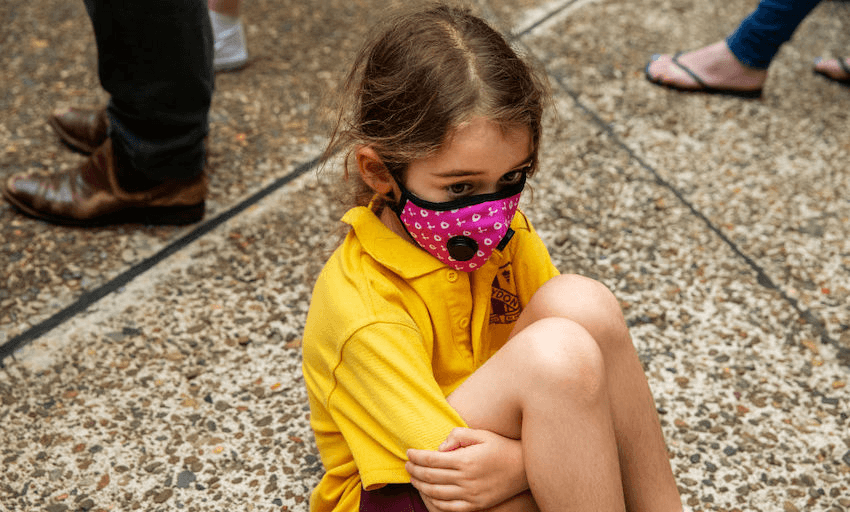 A young girl wearing a mask looks on during a rally for climate action at Sydney Town Hall on December 11, 2019 in Sydney, Australia. (Photo by Jenny Evans/Getty Images)