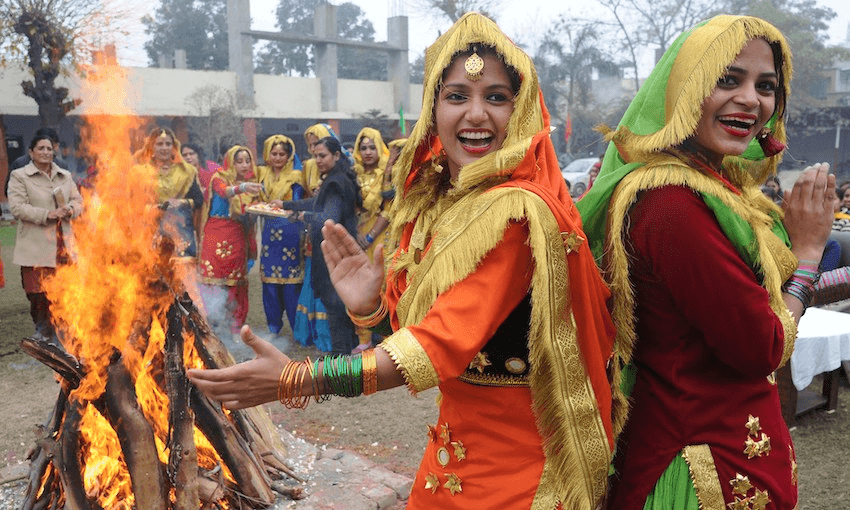 Women wearing traditional Punjabi dress perform the giddha folk dance around a bonfire during Lohri celebrations in Amritsar in 2015 (Photo: NARINDER NANU/AFP via Getty Images)