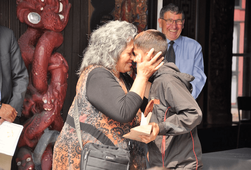 Te Pou Taurahere graduate Boston Rangi-Whaikawa-Henry is embraced by  his proud nanny, Aileen Rangi-Whaikawa-Mills (Photo: Supplied) 
