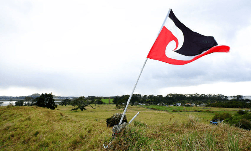 The Tino Rangatiratanga flag flies on the maunga at Ihumātao. (Photo by Phil Walter/Getty Images) 
