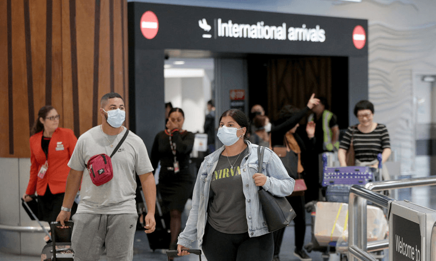 Passengers arriving on flights in January wear protective masks at Auckland International Airport (Photo by Dave Rowland/Getty Images) 
