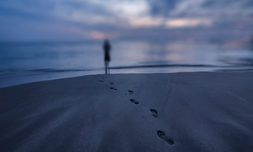 A woman walks to the beach at sunset. Photo: Getty Images. 
