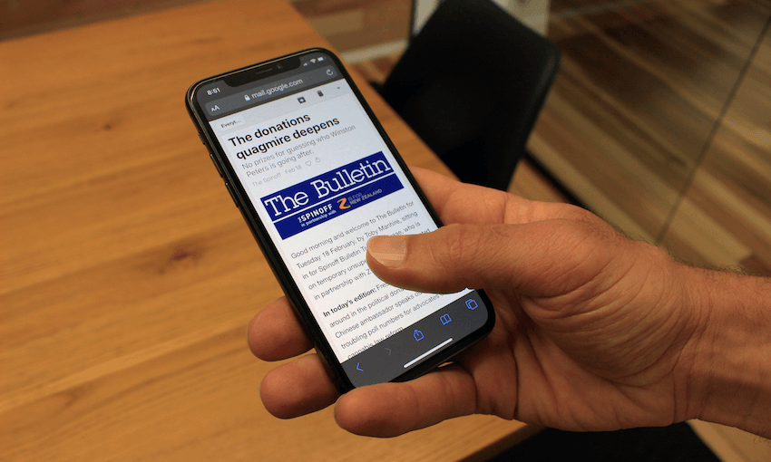 Image: The hand of a person gaining insight and knowledge by reading The Bulletin