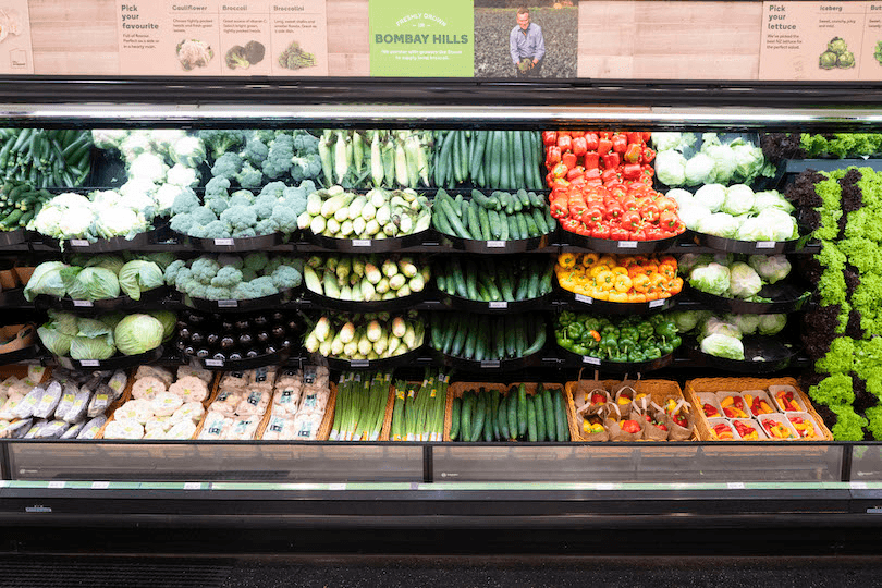a supermarket with lots of veges allpiled neatly without any of those flimsy plastic bags
