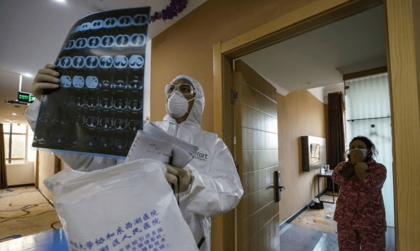 A doctor looking at a lung CT image in Wuhan. (Photo by STR/AFP via Getty Images)
