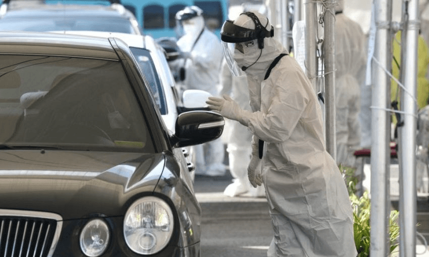 A coronavirus, at a “drive-through” virus test facility in Goyang, north of Seoul (Photo by JUNG YEON-JE/AFP via Getty Images) 
