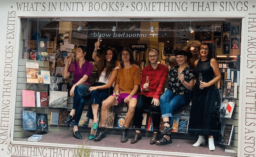 The staff of Unity Books Auckland raise a glass to their huge win (Photo: instagram.com/unitybooksauckland)  
