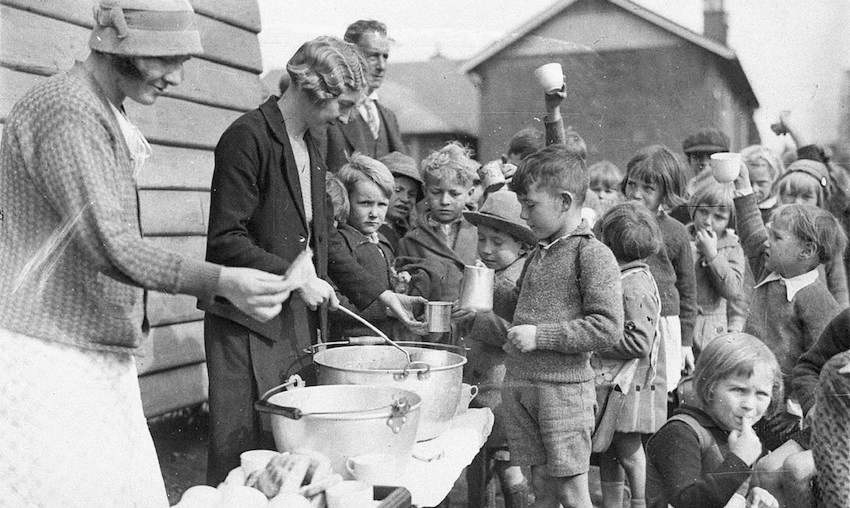 Schoolchildren line up for free issue of soup and a slice of bread in the Depression, Belmore North Public School, Sydney, 2 August 1934 (From the collection of the State Library of New South Wales www.sl.nsw.gov.au) 
