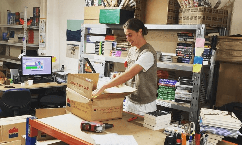 Fergus unpacking stock in the basement of Unity Auckland. Image: supplied. 
