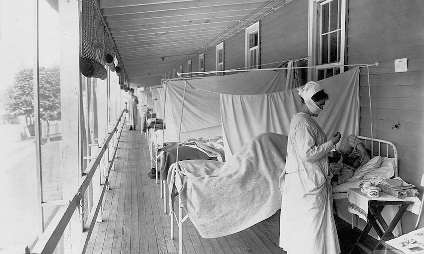 A nurse takes a patient’s pulse in an influenza ward during the 1918 pandemic  (Photo: Getty Images) 
