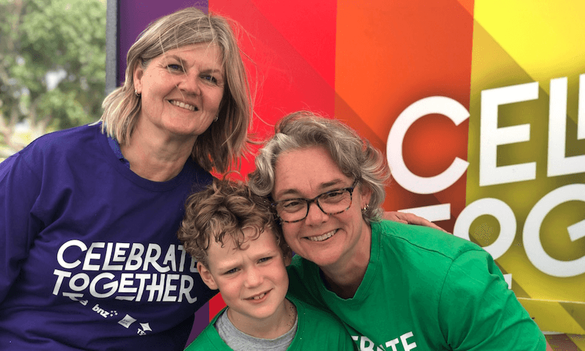 Liz Knight, the chief risk officer at Kiwibank, and her family at Out in the Park, flying the Kiwibank flag. (Photo: Supplied) 
