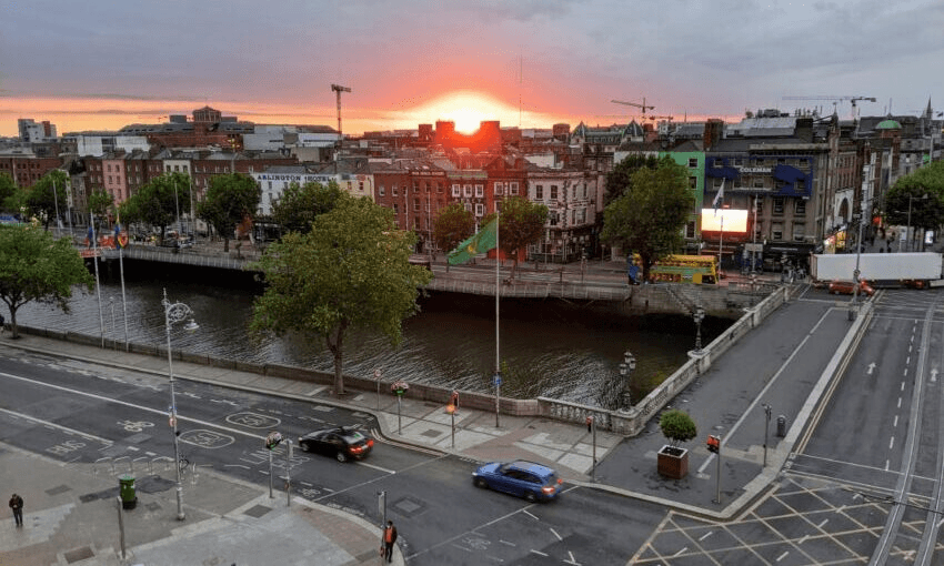 The sun sets behind Dublin’s River Liffey on a summer evening in June. Photo: Julia Mahony 
