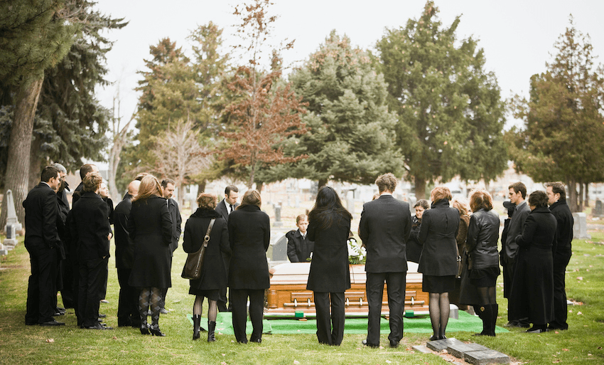 a group of mourners gather